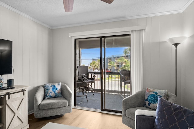 6001 N Ocean Blvd Unit 137, North Myrtle Beach, SC 29582 - sitting room with crown molding, a textured ceiling, light wood-type flooring, a ceiling fan, and a desk