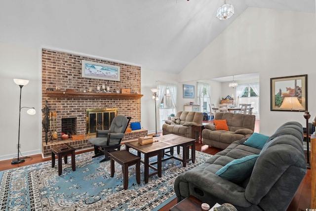 528 George Washington Trl, Georgetown, SC 29440 - living room with a chandelier, wood finished floors, a brick fireplace, and high vaulted ceiling