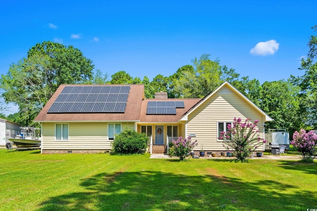 528 George Washington Trl, Georgetown, SC 29440 - view of front of home with crawl space, solar panels, a front yard, roof with shingles, and a chimney