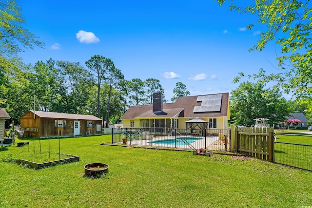 528 George Washington Trl, Georgetown, SC 29440 - view of swimming pool featuring a fenced backyard, a fire pit, a sunroom, an outdoor structure, and a patio