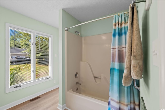 528 George Washington Trl, Georgetown, SC 29440 - bathroom with shower / bath combo, wood finished floors, and a textured ceiling