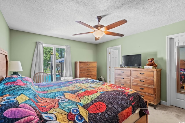 528 George Washington Trl, Georgetown, SC 29440 - bedroom featuring access to exterior, light carpet, ceiling fan, and a textured ceiling
