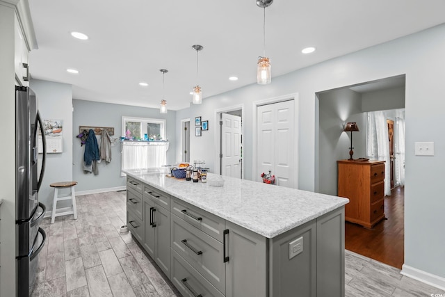 528 George Washington Trl, Georgetown, SC 29440 - kitchen featuring gray cabinetry, stainless steel fridge with ice dispenser, light wood-style flooring, hanging light fixtures, and recessed lighting