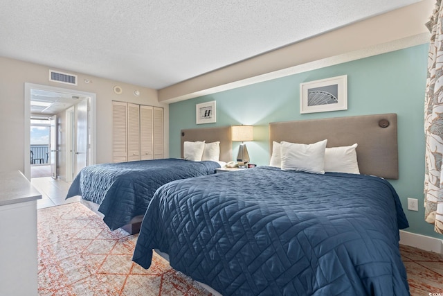 2000 N Ocean Blvd Unit 1206, Myrtle Beach, SC 29577 - bedroom featuring a textured ceiling and a closet