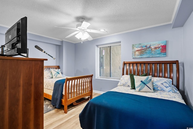 517 S Ocean Blvd Unit 705, North Myrtle Beach, SC 29582 - bedroom with light wood-type flooring, ornamental molding, a textured ceiling, and a ceiling fan