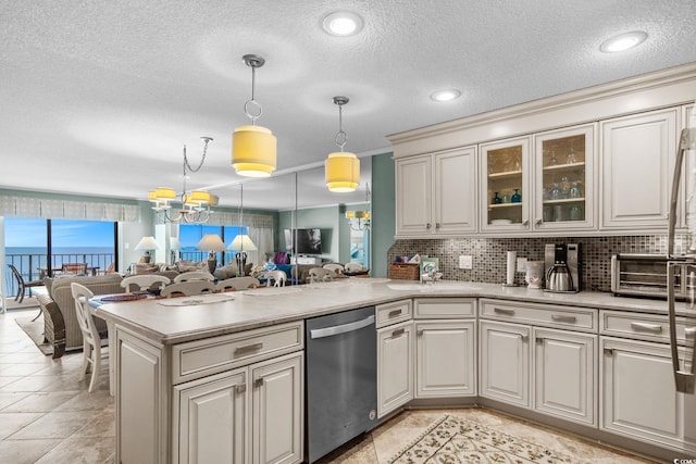 517 S Ocean Blvd Unit 705, North Myrtle Beach, SC 29582 - kitchen featuring dishwasher, a peninsula, open floor plan, light countertops, and a textured ceiling