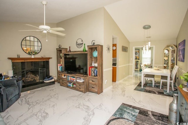 654 Blue Bird Ln, Murrells Inlet, SC 29576 - living room with a ceiling fan, a tile fireplace, marble finish floors, and vaulted ceiling