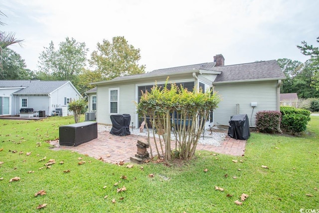 654 Blue Bird Ln, Murrells Inlet, SC 29576 - back of house featuring a patio, a yard, and a chimney