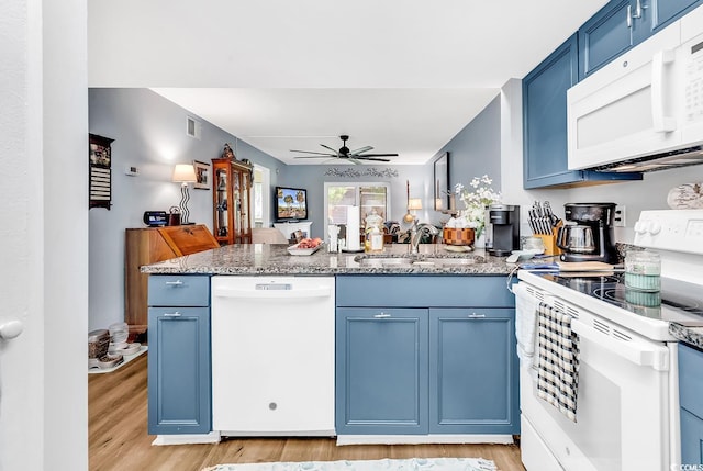 1301 Pridgen Rd Unit 903, Myrtle Beach, SC 29577 - kitchen featuring white appliances, blue cabinets, a peninsula, and light wood-style floors