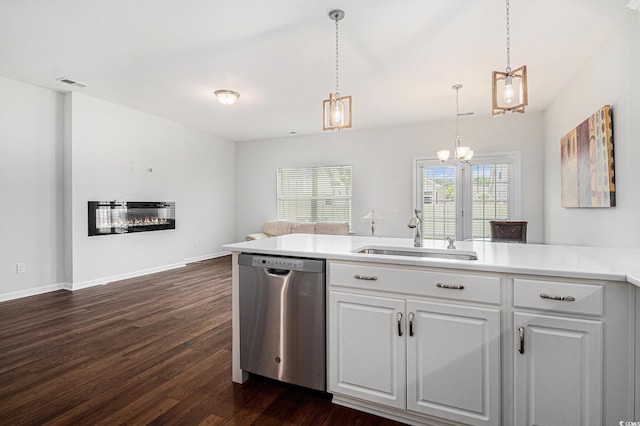 4051 Mclamb Ave Unit 4051, Little River, SC 29566 - kitchen featuring stainless steel dishwasher, dark wood-style floors, a chandelier, a glass covered fireplace, and white cabinetry