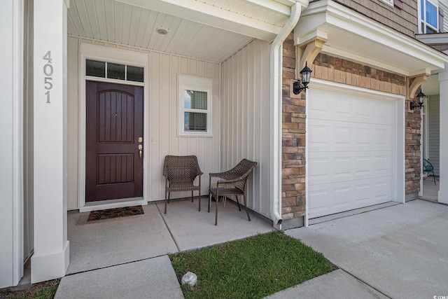 4051 Mclamb Ave Unit 4051, Little River, SC 29566 - view of exterior entry with stone siding, an attached garage, and concrete driveway