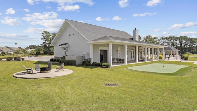 4051 Mclamb Ave Unit 4051, Little River, SC 29566 - back of property featuring a patio area, an area to practice putting, a fire pit, ceiling fan, and a chimney