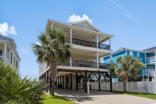 221 N Waccamaw Dr, Murrells Inlet, SC 29576 - view of front of house featuring a carport, a balcony, and concrete driveway