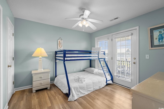 221 N Waccamaw Dr, Murrells Inlet, SC 29576 - bedroom with wood finished floors, access to exterior, and a ceiling fan