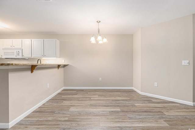 4645 Fringetree Dr Unit 10B, Murrells Inlet, SC 29576 - unfurnished dining area with a chandelier and light wood-style flooring