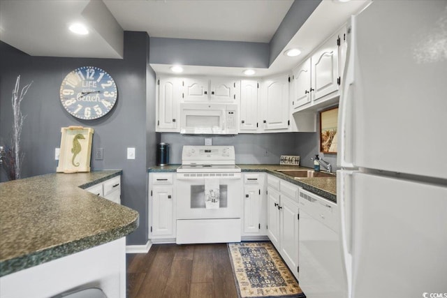 4222 Pinehurst Dr Unit I-9, Little River, SC 29566 - kitchen featuring white appliances, dark countertops, dark wood-style floors, white cabinetry, and recessed lighting