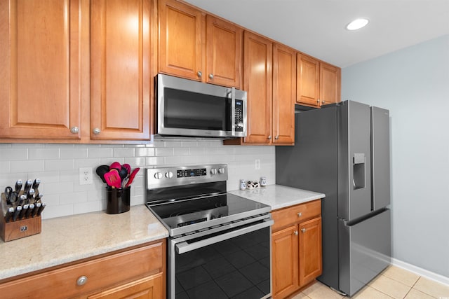 864 Barn Owl Ct Unit 864, Myrtle Beach, SC 29579 - kitchen featuring appliances with stainless steel finishes, light tile patterned flooring, backsplash, brown cabinets, and recessed lighting