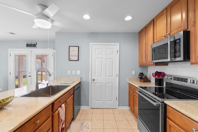 864 Barn Owl Ct Unit 864, Myrtle Beach, SC 29579 - kitchen featuring appliances with stainless steel finishes, brown cabinets, light countertops, tasteful backsplash, and light tile patterned floors