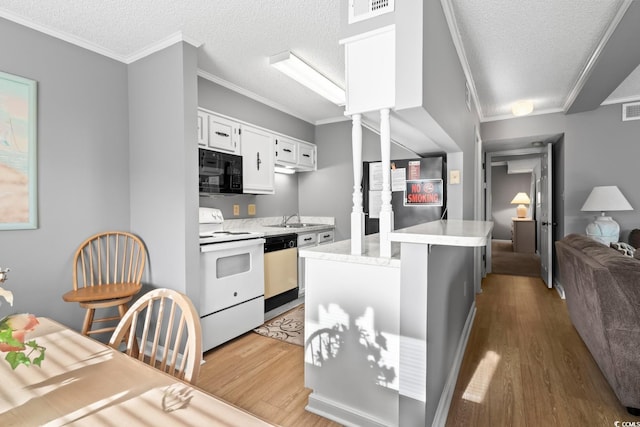609 Hillside Dr S Unit D-17, North Myrtle Beach, SC 29582 - kitchen featuring white range with electric stovetop, black microwave, dishwashing machine, light wood-style floors, and a textured ceiling