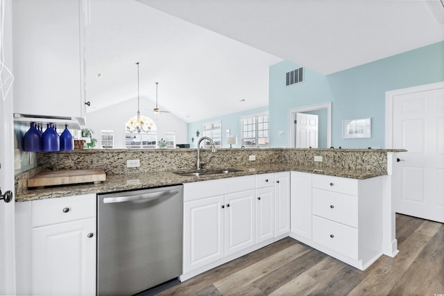 204 24th Ave N, North Myrtle Beach, SC 29582 - kitchen with dishwasher, wood finished floors, white cabinets, dark stone counters, and vaulted ceiling