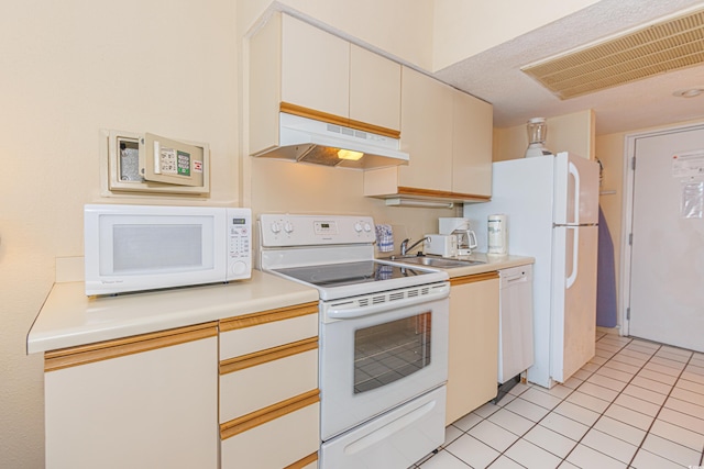 1304 N Ocean Blvd Unit S-204, Myrtle Beach, SC 29577 - kitchen featuring white appliances, under cabinet range hood, light countertops, and light tile patterned floors