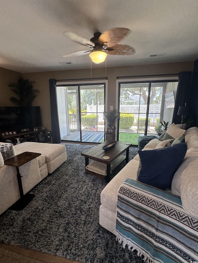 1851 Colony Dr Unit 5M, Surfside Beach, SC 29575 - carpeted living room with a ceiling fan and a textured ceiling
