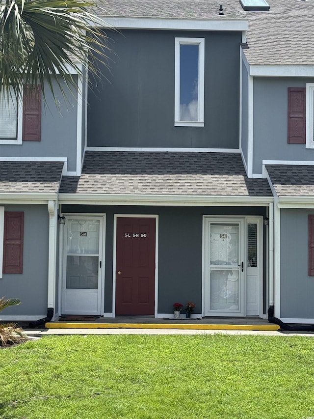 1851 Colony Dr Unit 5M, Surfside Beach, SC 29575 - view of front of house featuring a front lawn and roof with shingles