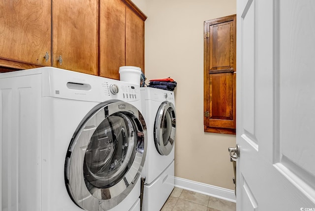 315 14th Ave N, Surfside Beach, SC 29575 - laundry area with washing machine and dryer, cabinet space, and light tile patterned floors