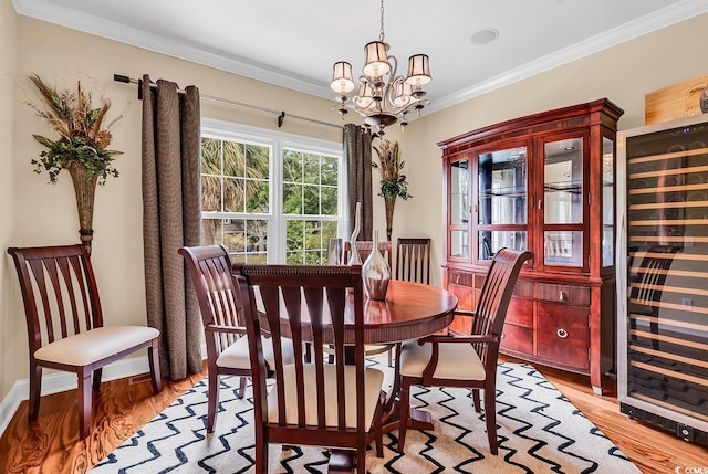 315 14th Ave N, Surfside Beach, SC 29575 - dining space with beverage cooler, ornamental molding, light wood-type flooring, and a chandelier