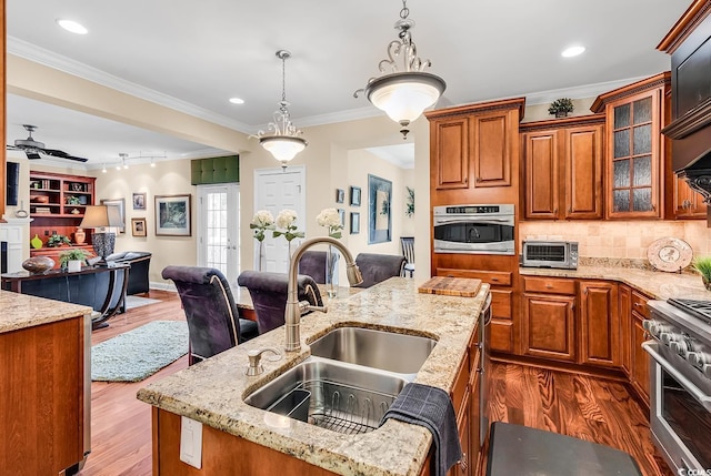 315 14th Ave N, Surfside Beach, SC 29575 - kitchen with open floor plan, stainless steel appliances, brown cabinetry, dark wood-style floors, and crown molding