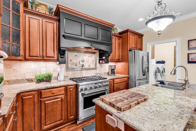 315 14th Ave N, Surfside Beach, SC 29575 - kitchen with appliances with stainless steel finishes, washing machine and dryer, crown molding, glass insert cabinets, and brown cabinetry