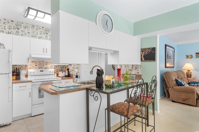500 Eagle Way Unit 19, Little River, SC 29566 - kitchen featuring white appliances, under cabinet range hood, white cabinetry, and backsplash