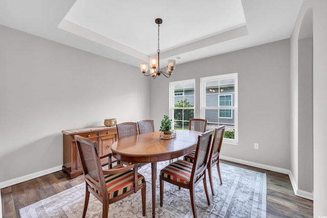 1276 Brighton Hill Ave, Myrtle Beach, SC 29588 - dining space featuring a raised ceiling, a chandelier, wood finished floors, and arched walkways