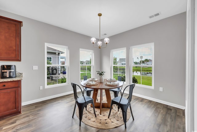 1276 Brighton Hill Ave, Myrtle Beach, SC 29588 - dining area with dark wood-style flooring, a chandelier, and a water view