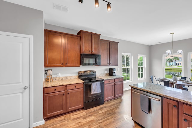 1276 Brighton Hill Ave, Myrtle Beach, SC 29588 - kitchen with black appliances, light wood-type flooring, light stone counters, and hanging light fixtures