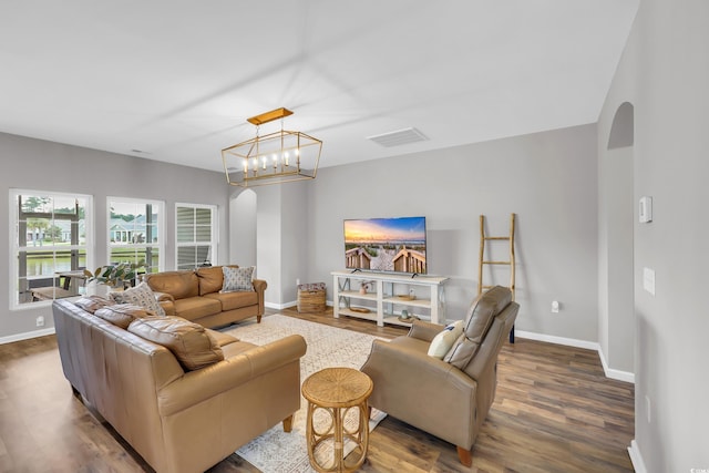 1276 Brighton Hill Ave, Myrtle Beach, SC 29588 - living area with arched walkways, dark wood-style floors, and a chandelier