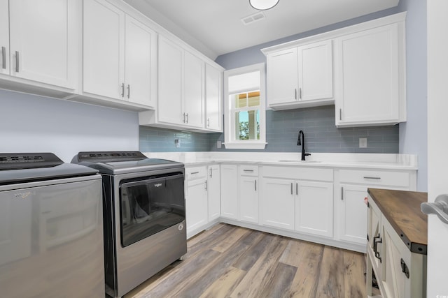 137 Pottery Landing Dr, Conway, SC 29527 - laundry room with washer and clothes dryer, cabinet space, and light wood finished floors