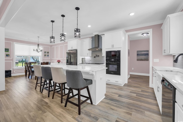 137 Pottery Landing Dr, Conway, SC 29527 - kitchen featuring black appliances, wall chimney exhaust hood, light wood-style flooring, white cabinetry, and recessed lighting