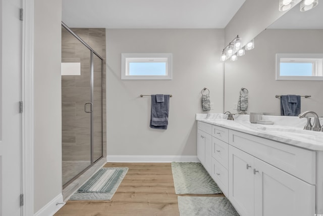 146 Marblehead Dr, Little River, SC 29566 - bathroom with healthy amount of natural light, double vanity, a shower stall, and wood finished floors