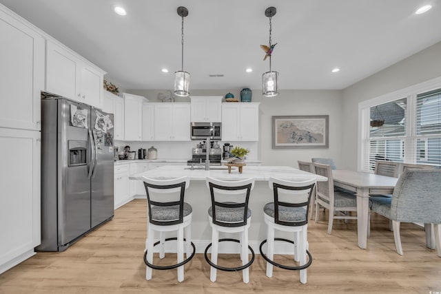 146 Marblehead Dr, Little River, SC 29566 - kitchen with appliances with stainless steel finishes, light countertops, recessed lighting, white cabinetry, and light wood-type flooring