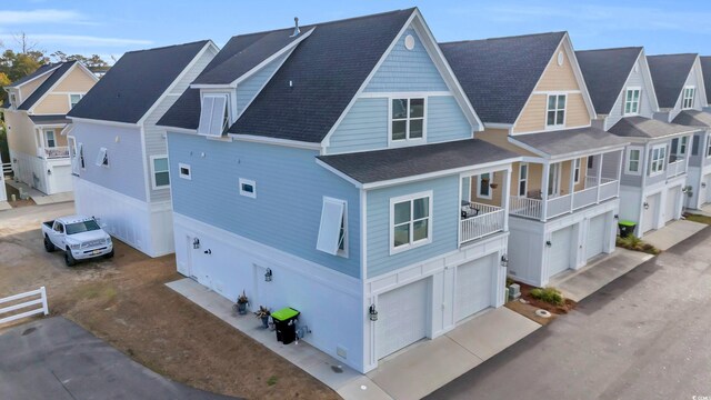 146 Marblehead Dr, Little River, SC 29566 - view of side of home featuring a garage, roof with shingles, a residential view, and driveway