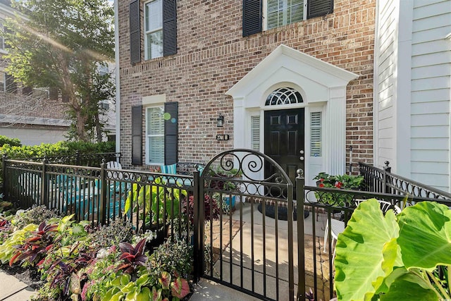 2761 Kruzel St Unit H, Myrtle Beach, SC 29577 - view of exterior entry featuring brick siding and a gate