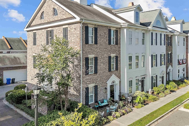 2761 Kruzel St Unit H, Myrtle Beach, SC 29577 - view of property with brick siding and a chimney