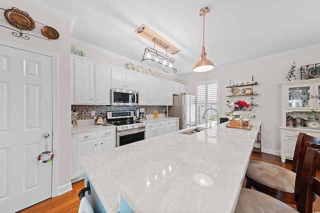 2761 Kruzel St Unit H, Myrtle Beach, SC 29577 - kitchen with stainless steel appliances, ornamental molding, a kitchen breakfast bar, light wood finished floors, and tasteful backsplash