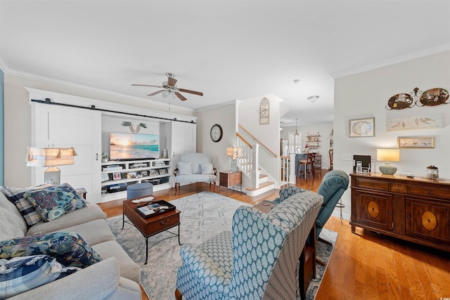 2761 Kruzel St Unit H, Myrtle Beach, SC 29577 - living room with a barn door, ornamental molding, ceiling fan, light wood-style floors, and stairway