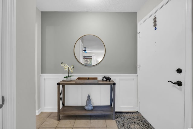 10301 N Kings Hwy Unit 21-4, Myrtle Beach, SC 29572 - entrance foyer with wainscoting, light tile patterned floors, a decorative wall, and ceiling fan