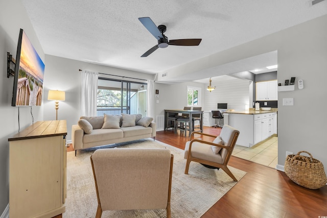 10301 N Kings Hwy Unit 21-4, Myrtle Beach, SC 29572 - living area with ceiling fan, light wood-type flooring, and a textured ceiling