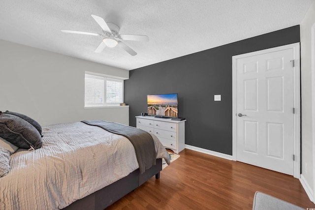 10301 N Kings Hwy Unit 21-4, Myrtle Beach, SC 29572 - bedroom featuring a textured ceiling, wood finished floors, and ceiling fan