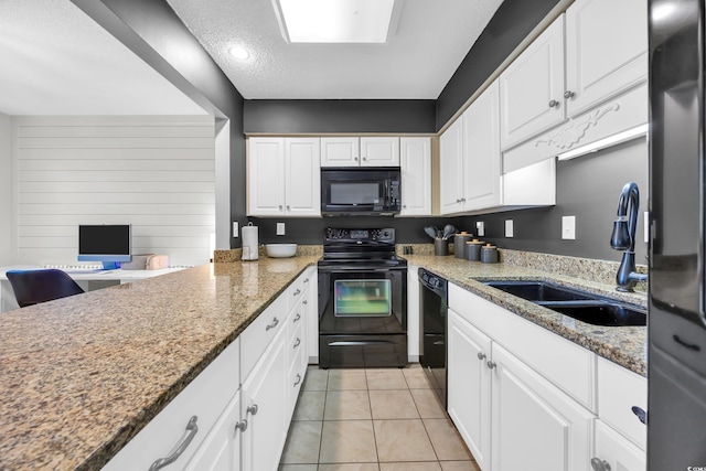 10301 N Kings Hwy Unit 21-4, Myrtle Beach, SC 29572 - kitchen featuring black appliances, white cabinetry, light tile patterned floors, a textured ceiling, and recessed lighting