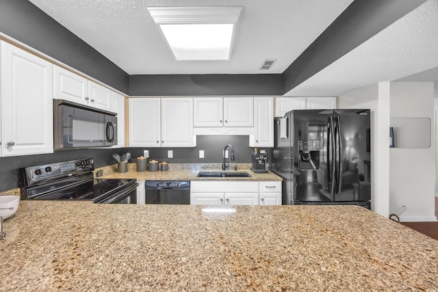 10301 N Kings Hwy Unit 21-4, Myrtle Beach, SC 29572 - kitchen featuring black appliances, white cabinets, and light stone counters